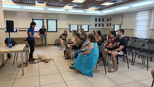 'Happening' participants listen to a lecture by a dog trainer in a classroom at the Center.